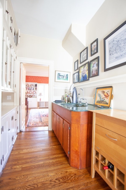 62 Pond Road Wellesley, MA 02482 - Photo 7 of 14 a large kitchen with stainless steel appliances granite countertop a large counter top and a view of living room