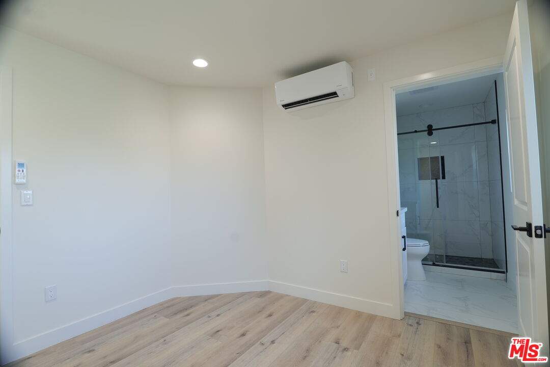 1338 West 30th Street Los Angeles, CA 90007 - Photo 13 of 21 a view of a room with wooden floor and a bathroom