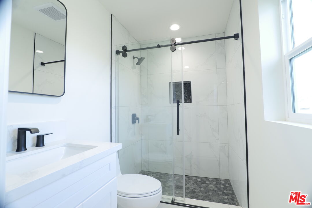 1338 West 30th Street Los Angeles, CA 90007 - Photo 16 of 21 a bathroom with a shower a toilet and a sink