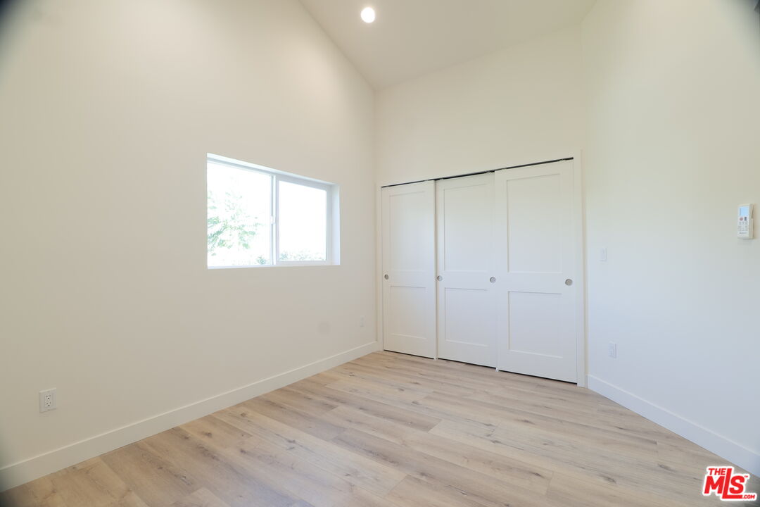 1338 West 30th Street Los Angeles, CA 90007 - Photo 17 of 21 a view of an empty room with wooden floor and a window