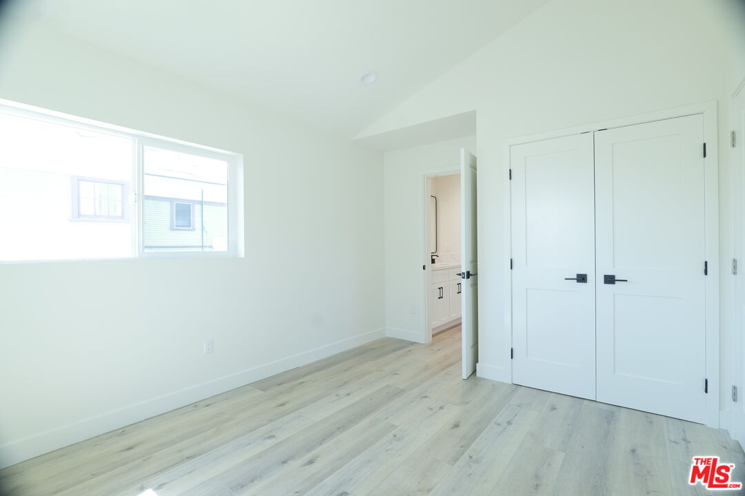 1338 West 30th Street Los Angeles, CA 90007 - Photo 19 of 21 a view of an empty room with wooden floor and a window