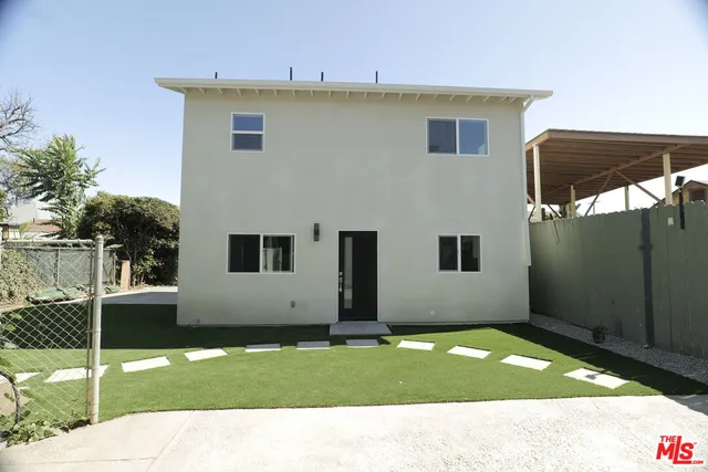 a backyard of a house with potted plants