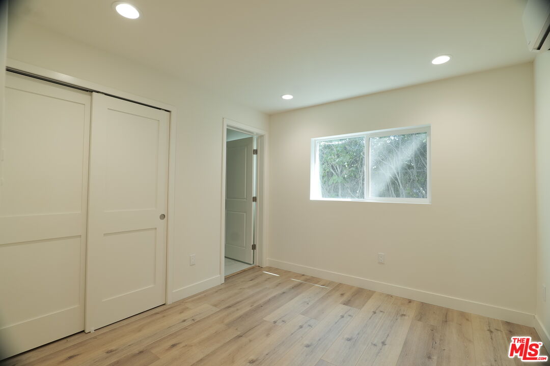 1338 West 30th Street Los Angeles, CA 90007 - Photo 5 of 21 a view of an empty room with wooden floor
