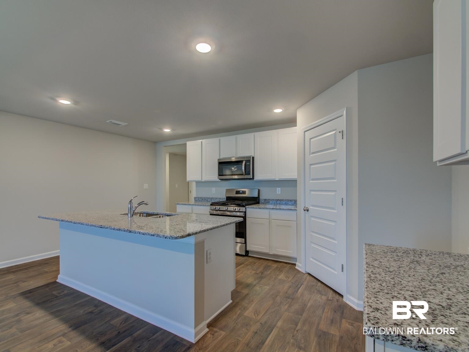 23952 Citation Loop Daphne, AL 36526 - Photo 13 of 69 Kitchen featuring stainless steel appliances, light stone countertops, recessed lighting, dark wood finished floors, and white cabinets