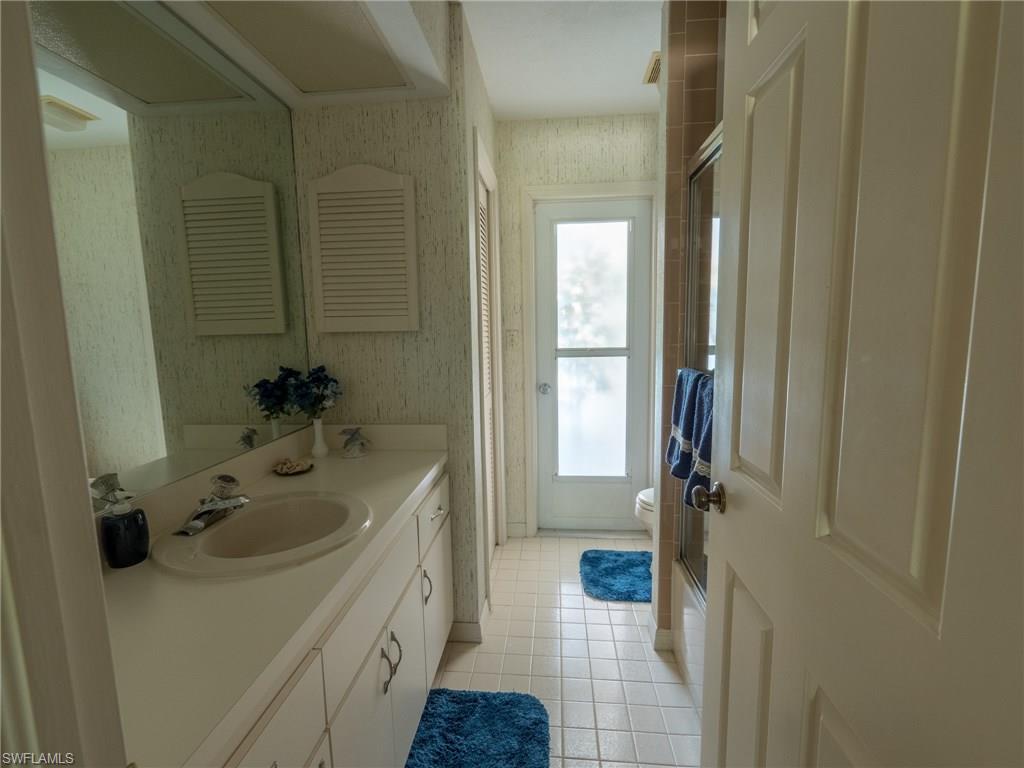 501 Springline Drive Naples, FL 34102 - Photo 13 of 14 a bathroom with a sink a toilet and shower