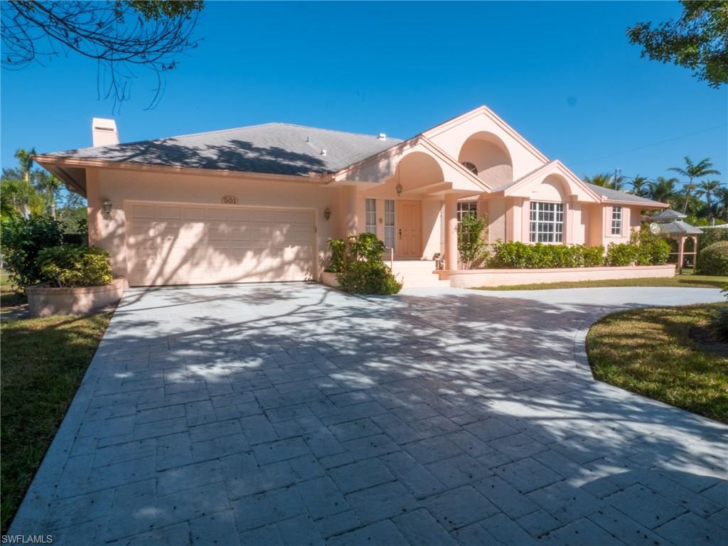 501 Springline Drive Naples, FL 34102 - Photo 3 of 14 a front view of a house with a yard