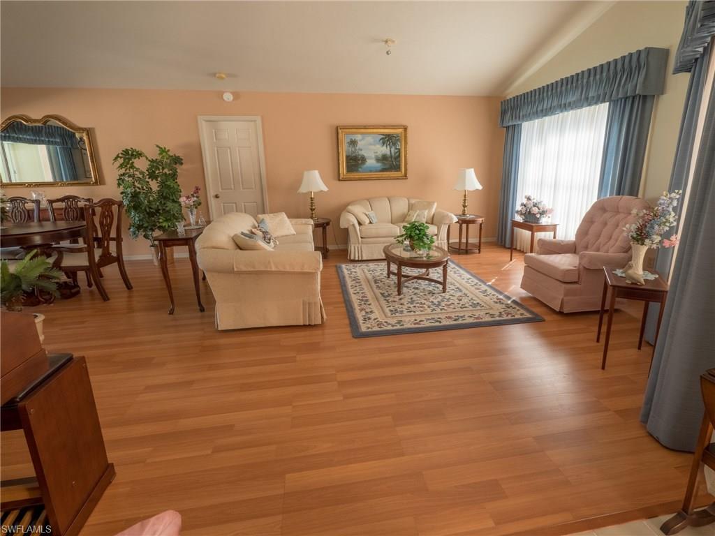 501 Springline Drive Naples, FL 34102 - Photo 4 of 14 a living room with furniture and wooden floor