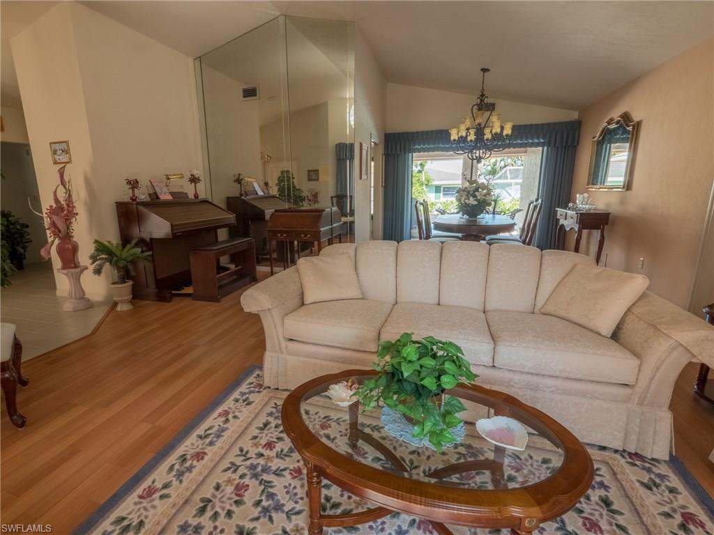501 Springline Drive Naples, FL 34102 - Photo 5 of 14 a living room with furniture and a chandelier