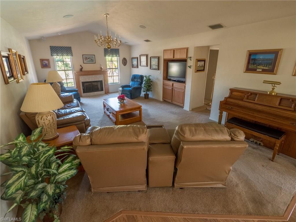 501 Springline Drive Naples, FL 34102 - Photo 7 of 14 a living room with furniture and a fireplace