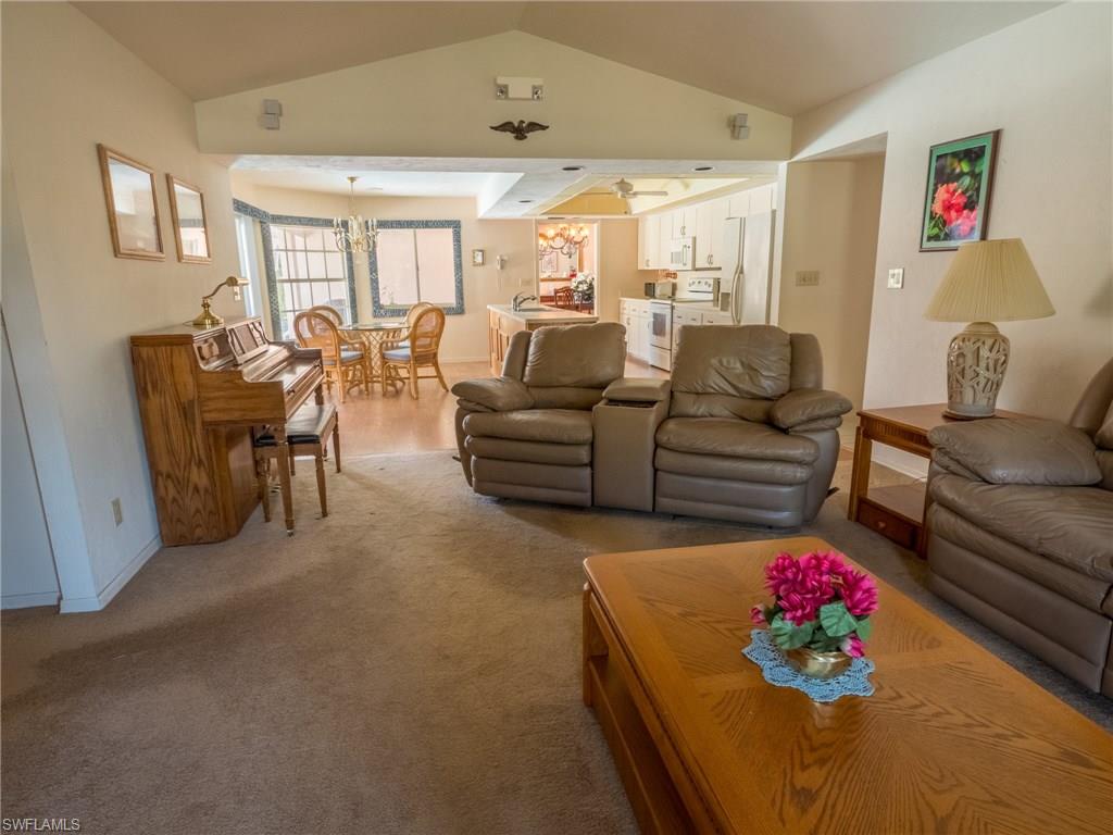 501 Springline Drive Naples, FL 34102 - Photo 8 of 14 a living room with furniture and a large window