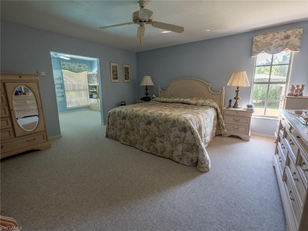 501 Springline Drive Naples, FL 34102 - Photo 9 of 14 a bedroom with a bed a couch and dresser