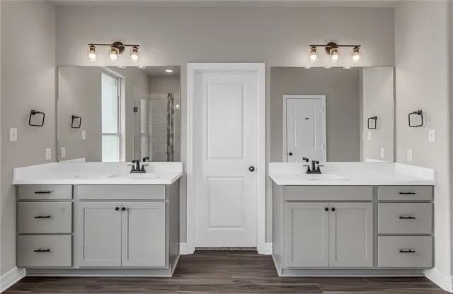a bathroom with a granite countertop sink a large mirror and a vanity