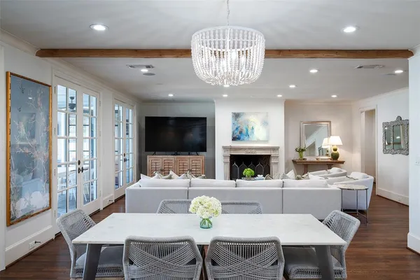 a view of a dining room with furniture a chandelier and wooden floor