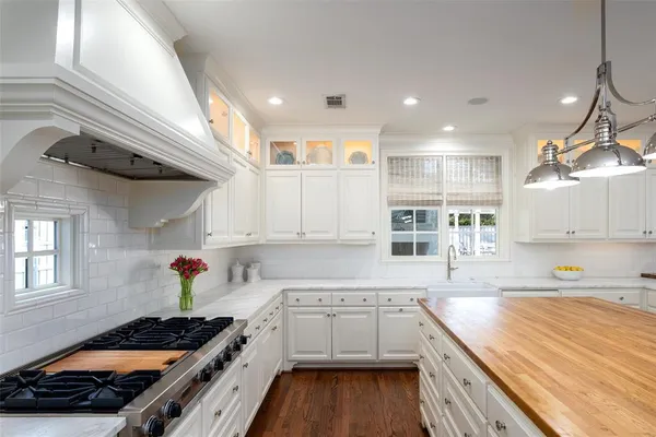 a kitchen with a sink stove and cabinets