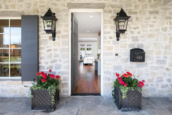 a front view of a house with flowers