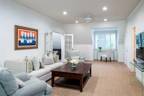 a living room with furniture a dining table and a flat screen tv