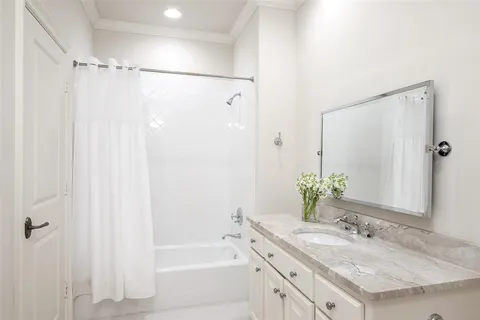 a bathroom with a granite countertop sink shower and a mirror