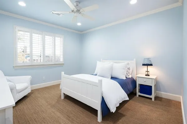 a bedroom with a bed and window