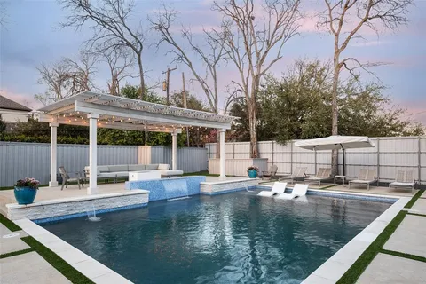 swimming pool view with a seating space