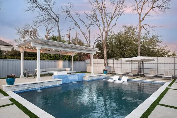 swimming pool view with a seating space