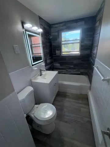 a bathroom with a toilet a sink and a mirror