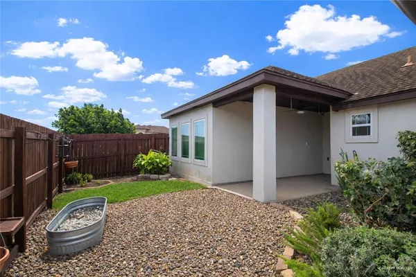 a view of a small house with a yard