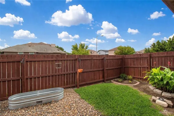 a view of a backyard with wooden fence