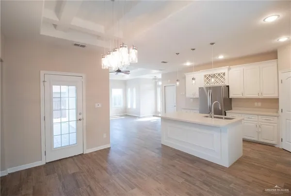 a view of kitchen with sink and wooden floor