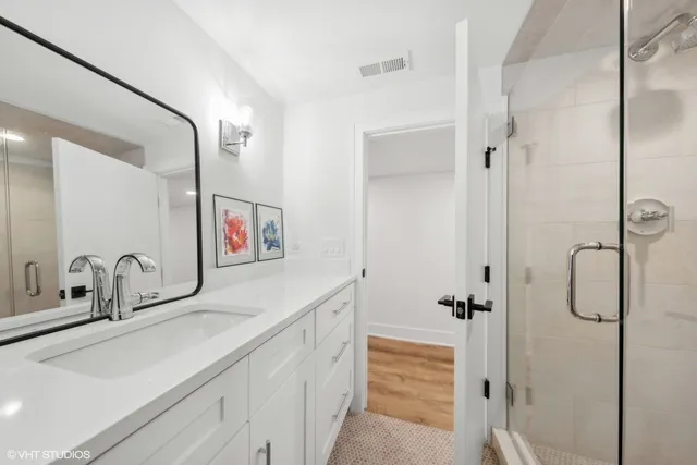 a bedroom with a bed and a view of kitchen