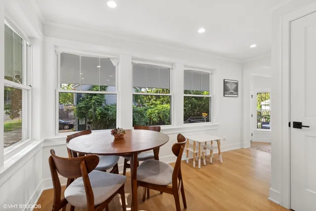 a living room with furniture and a large window with garden view