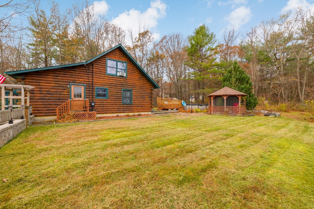 404 Rawson Street, Unit 404 Leicester, MA 01524 - Photo 4 of 13 a front view of house with yard and trees in the background