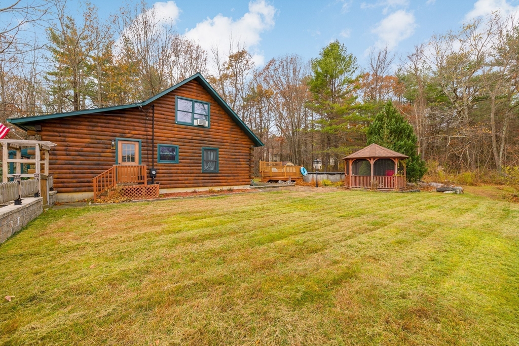404 Rawson Street, Unit 404 Leicester, MA 01524 - Photo 5 of 13 a front view of house with yard and trees in the background