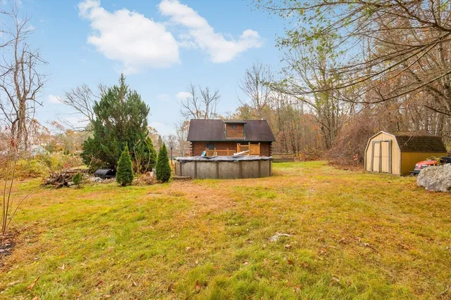 a house view with swimming pool in front of house