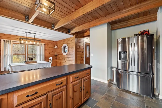 a kitchen with stainless steel appliances granite countertop a refrigerator and a sink
