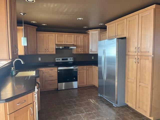 225 Larson Boulevard Rostraver Township, PA 15012 - Photo 4 of 15 a kitchen with stainless steel appliances granite countertop a refrigerator a stove and a sink with wooden cabinets