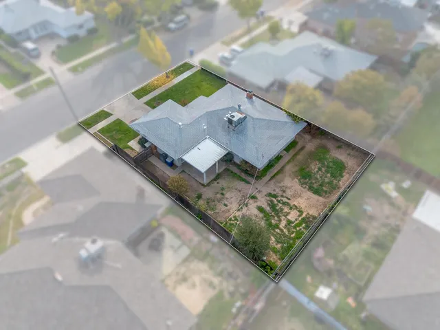 an aerial view of a house with a yard