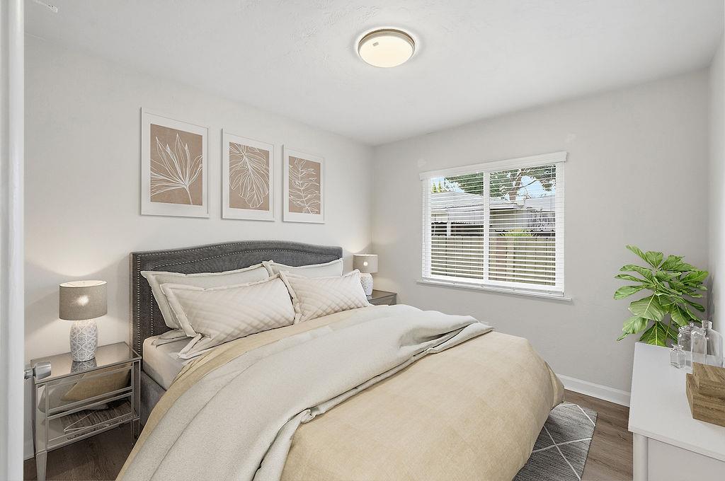 2999 East Richert Avenue Fresno, CA 93726 - Photo 8 of 19 a bedroom with a bed and a potted plant