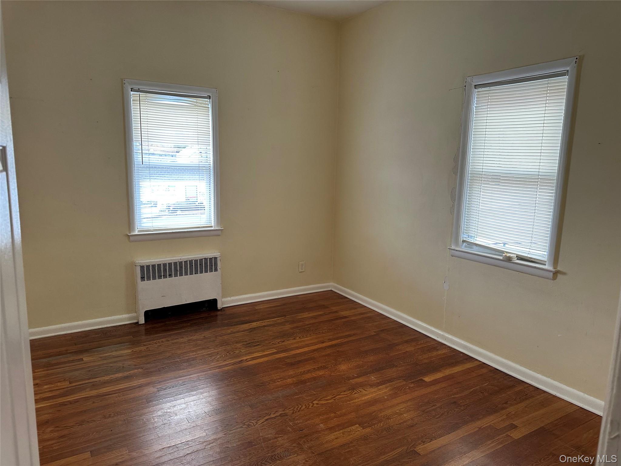 9 Webster Avenue, Unit 1 New Rochelle, NY 10801 - Photo 5 of 7 an empty room with wooden floor and windows