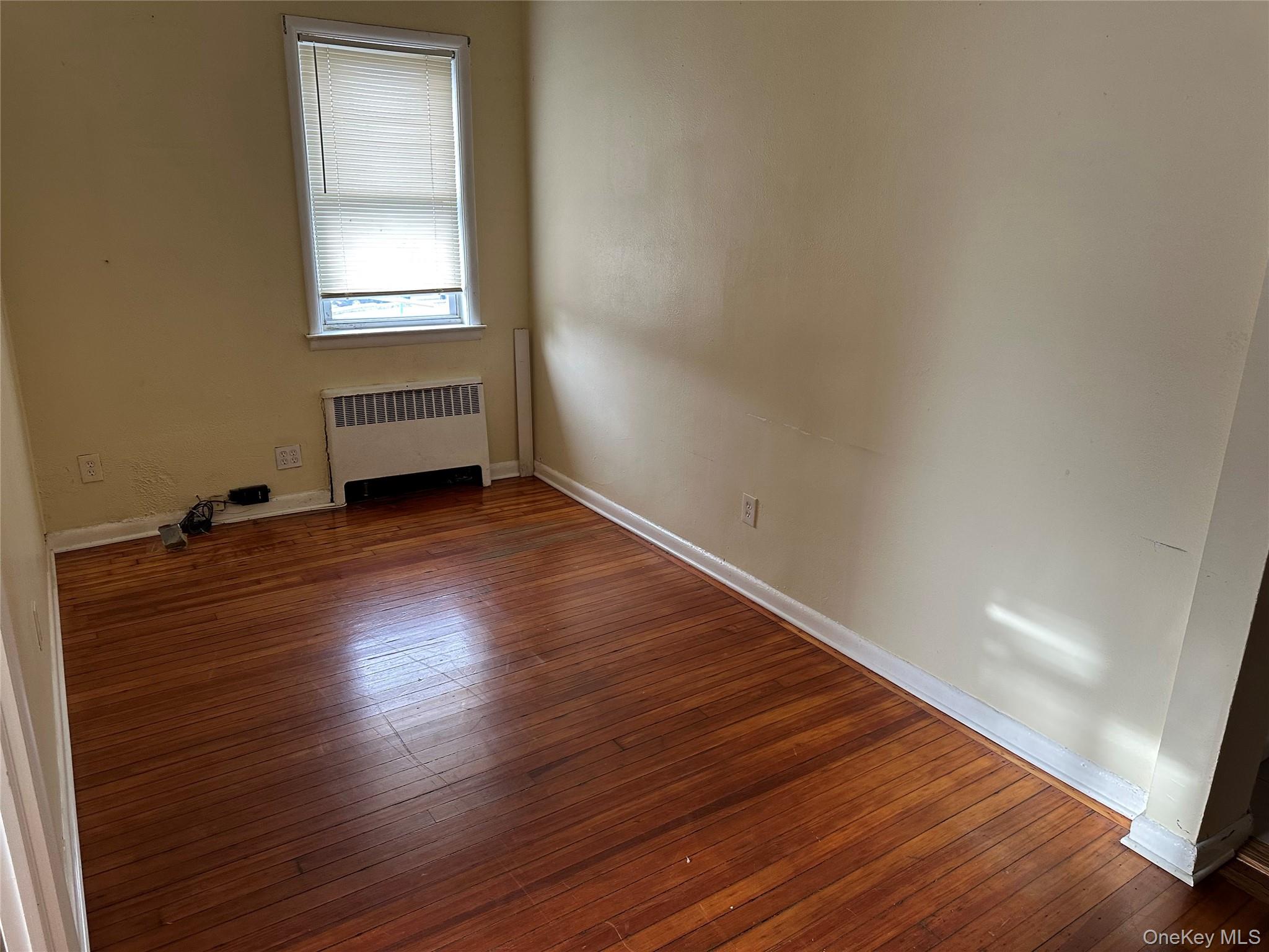 9 Webster Avenue, Unit 1 New Rochelle, NY 10801 - Photo 6 of 7 an empty room with wooden floor and windows