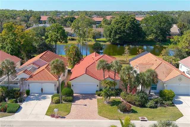 an aerial view of house with yard and lake view