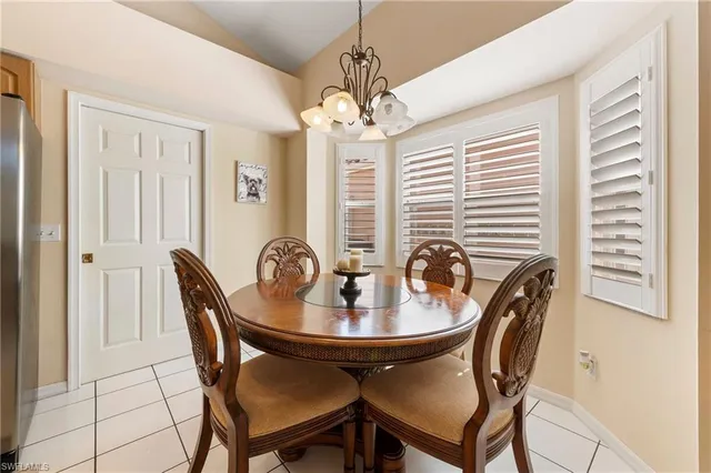 a dining room with furniture and window