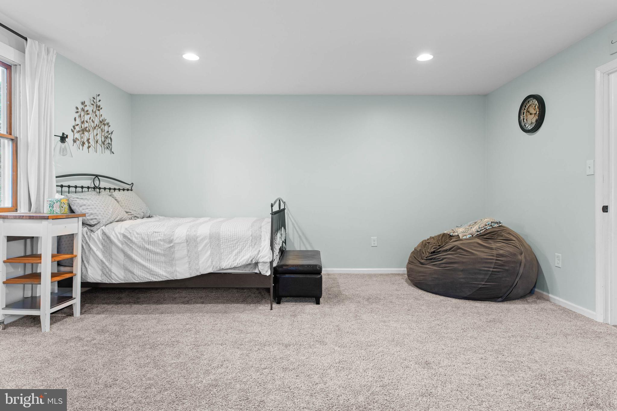 465 Briarhill Road Springfield, PA 19064 - Photo 17 of 51 a bedroom with a bed and a chair