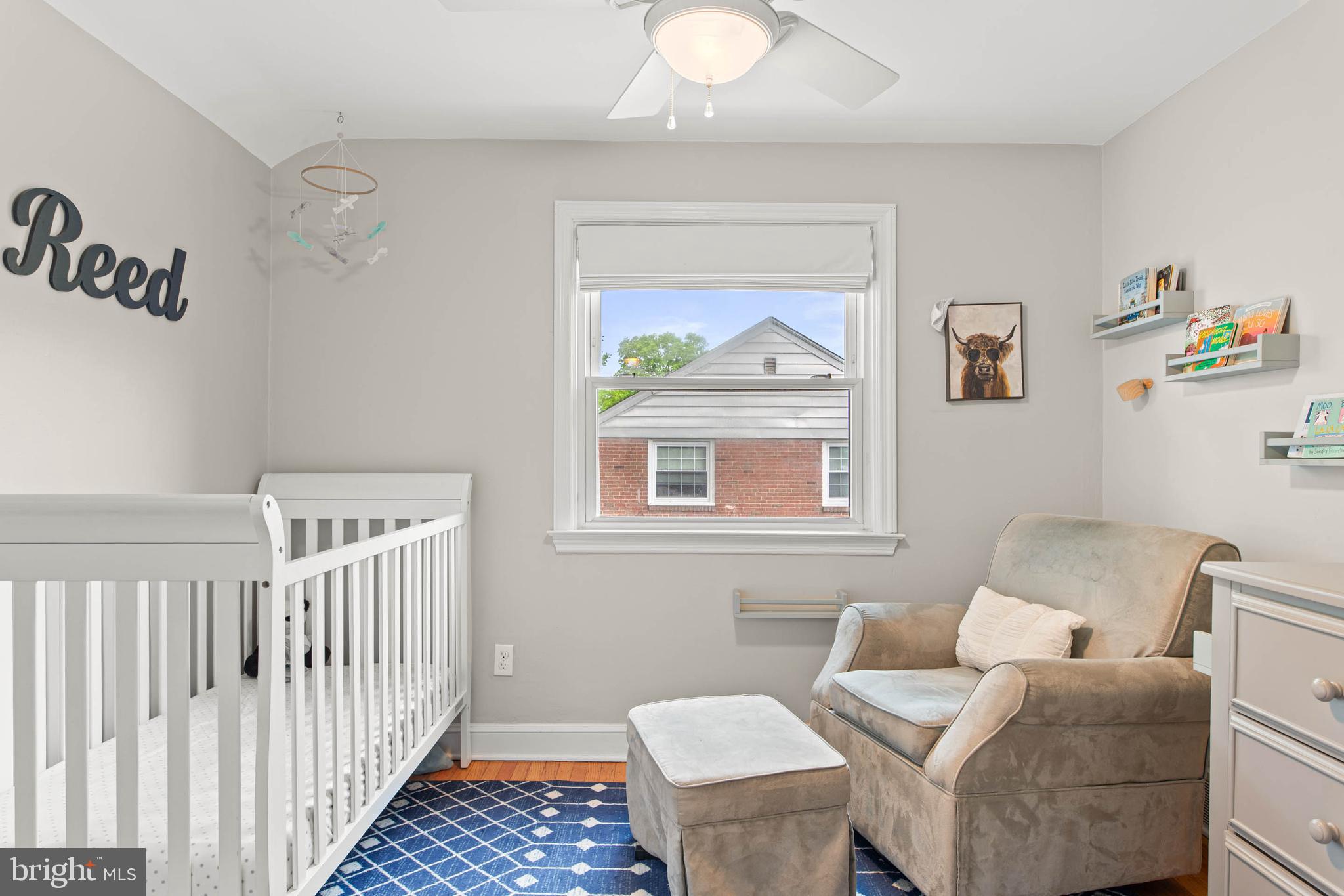 465 Briarhill Road Springfield, PA 19064 - Photo 36 of 51 a living room with furniture and a baby crib