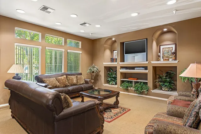 a living room with furniture and a floor to ceiling window