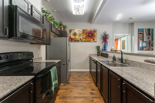 a kitchen that has a sink and a stove