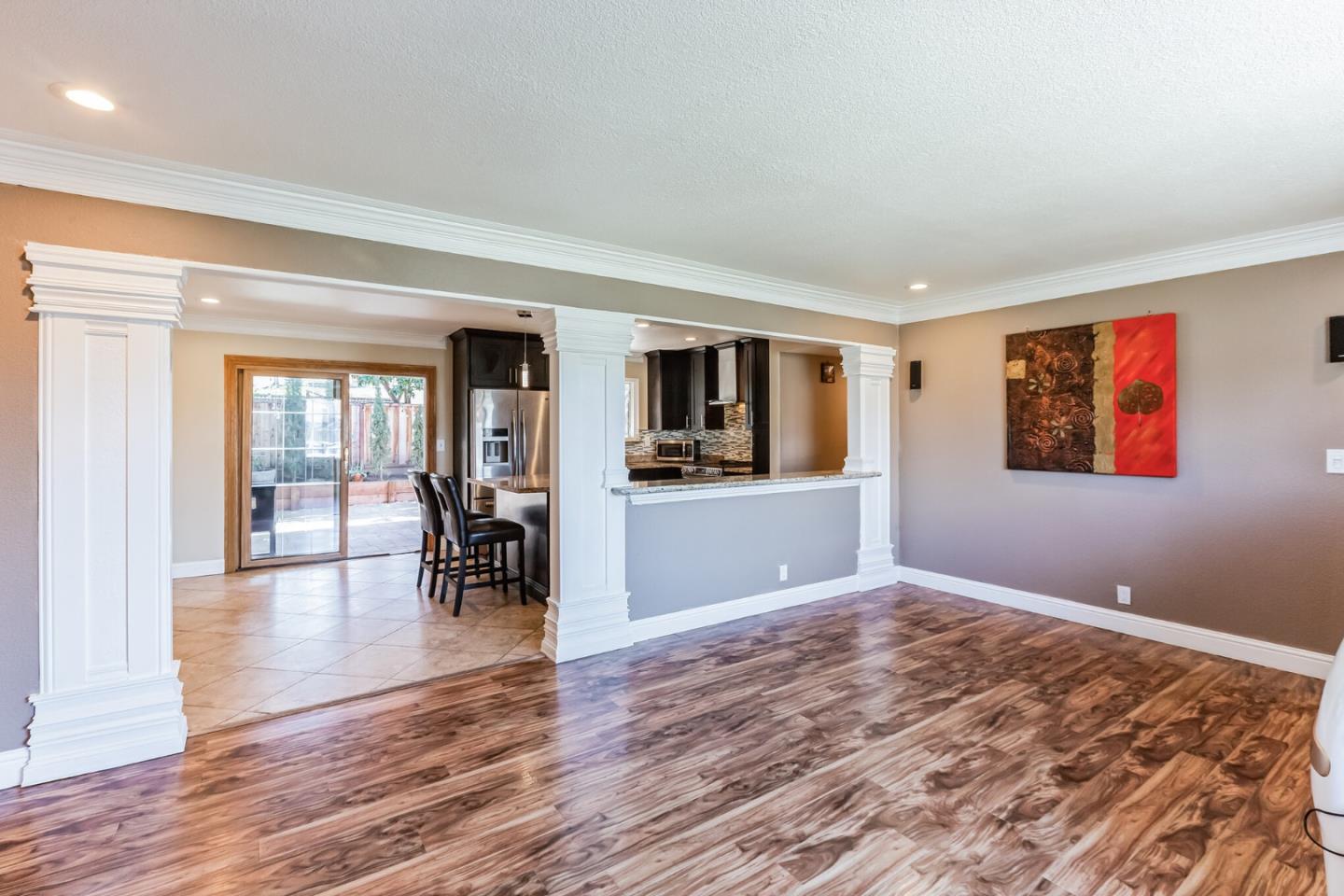 1430 Olympic Drive Milpitas, CA 95035 - Photo 5 of 21 a view of empty room with wooden floor and kitchen view