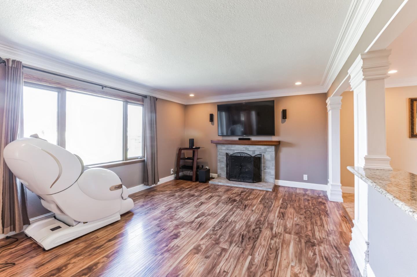 1430 Olympic Drive Milpitas, CA 95035 - Photo 7 of 21 a living room with furniture a fireplace and a flat screen tv