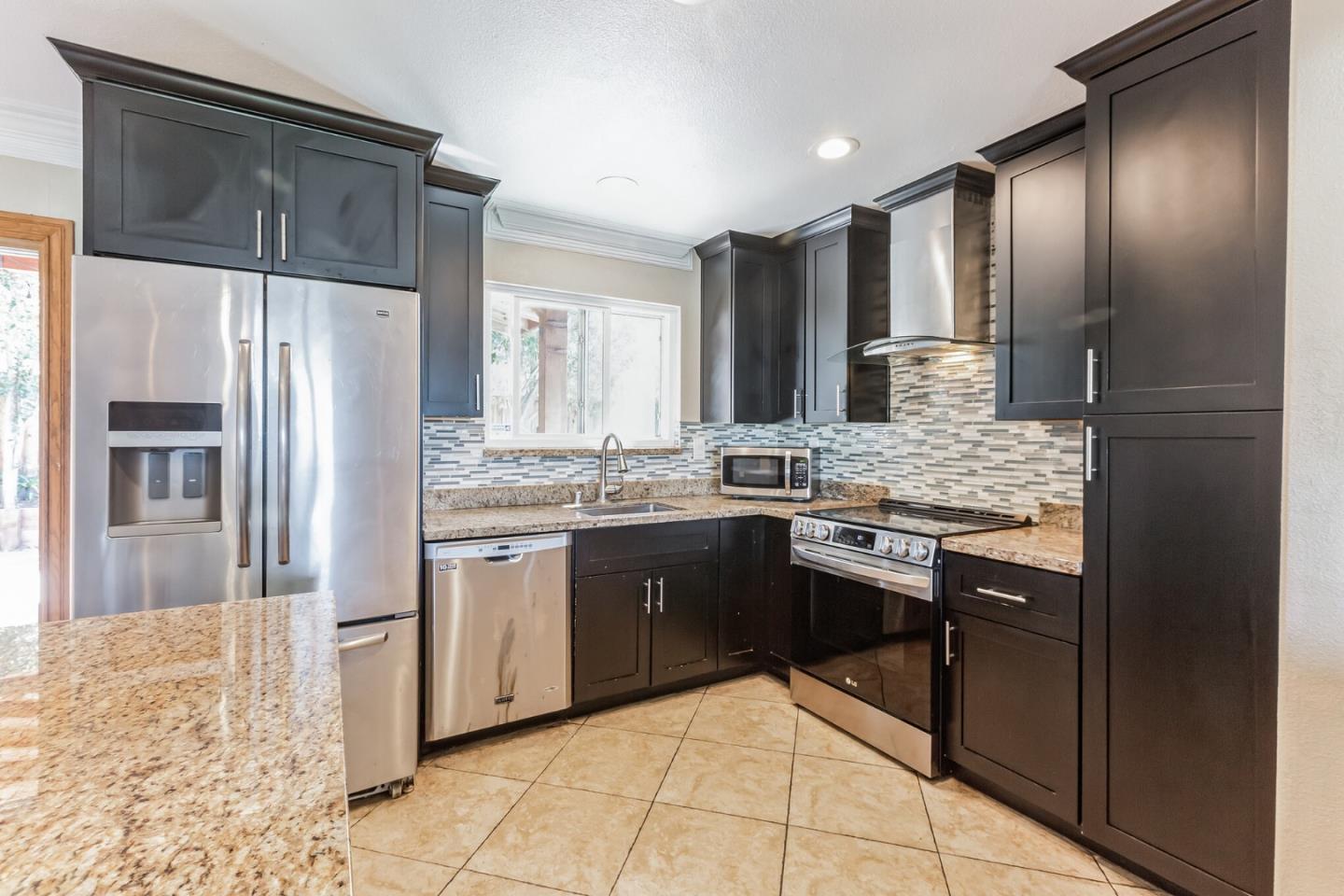 1430 Olympic Drive Milpitas, CA 95035 - Photo 9 of 21 a kitchen with stainless steel appliances granite countertop a refrigerator and a stove