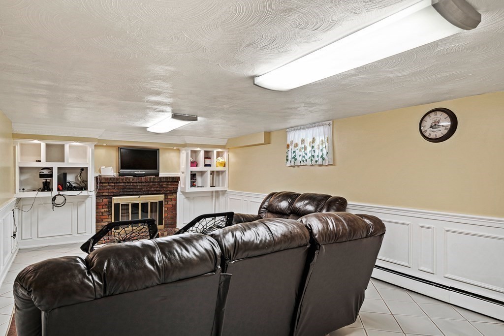 23 Webster Road Lexington, MA 02421 - Photo 20 of 32 a living room with furniture and a fireplace