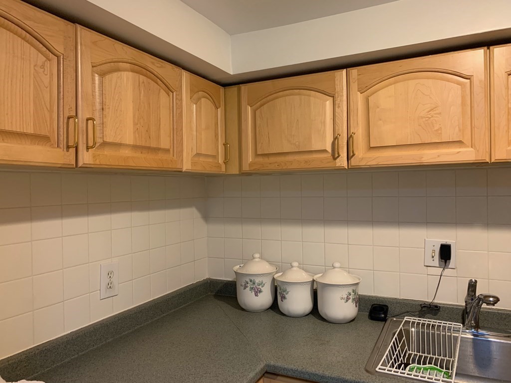 23 Webster Road Lexington, MA 02421 - Photo 22 of 32 a room with water heater and white cabinets
